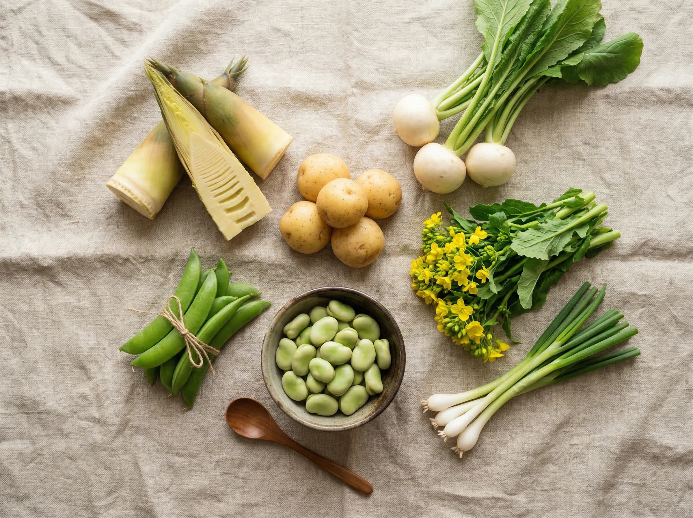 Fresh spring vegetables arranged on natural linen cloth